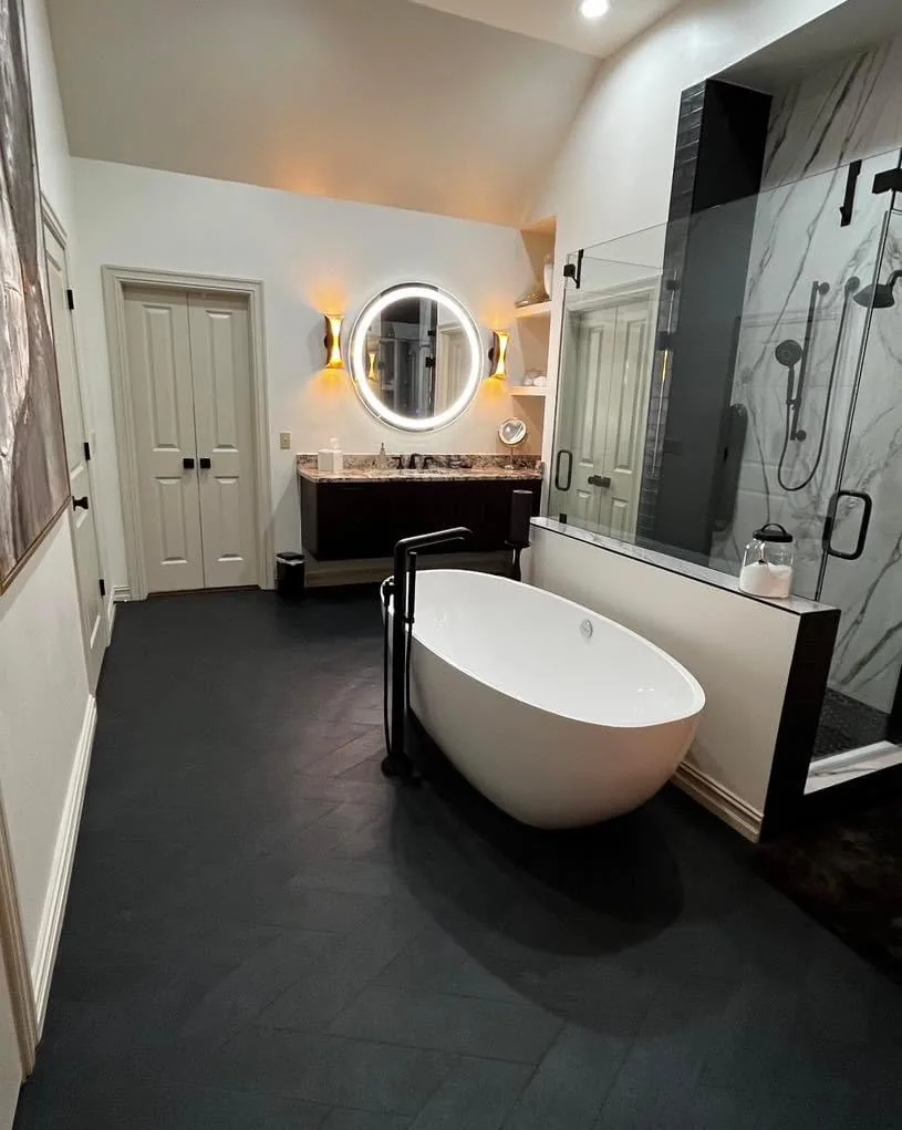 Finished bathroom renovation with freestanding tub and glass shower