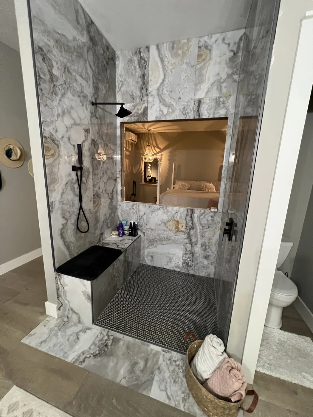 Finished marble-look walk-in shower with bench