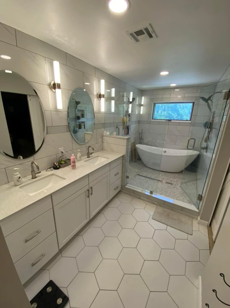 Finished bathroom renovation with freestanding tub and glass shower