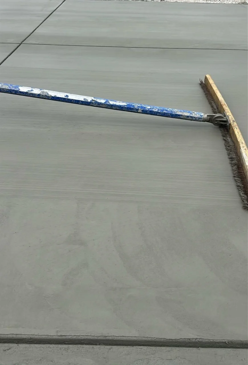 Fresh concrete being broom finished