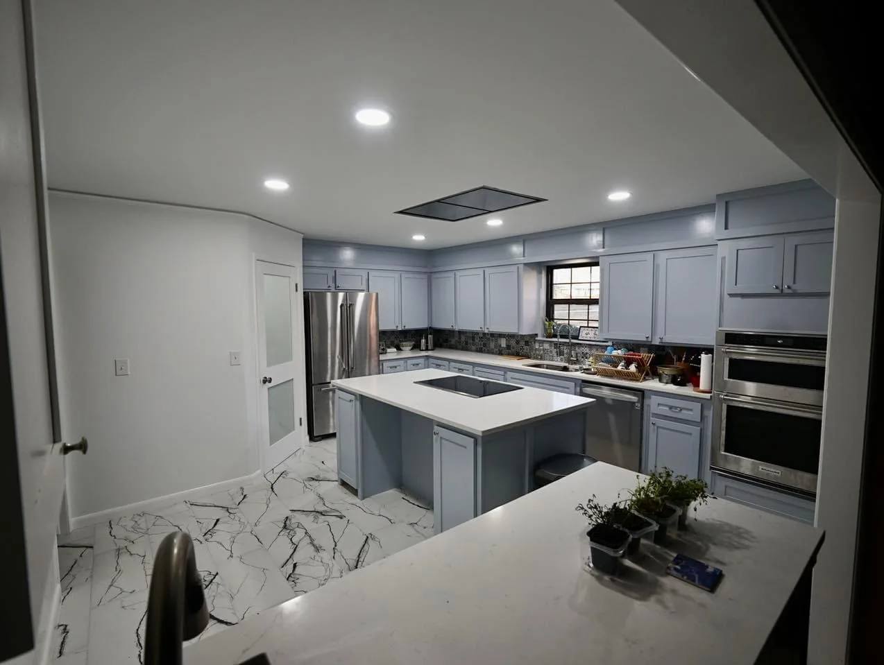 Finished blue gray kitchen renovation with island