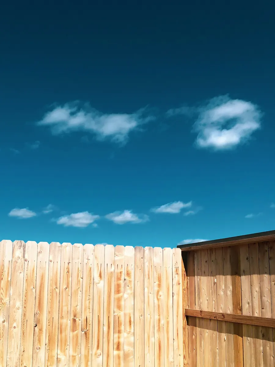 Clean wood fencing and exterior finish work under an open sky